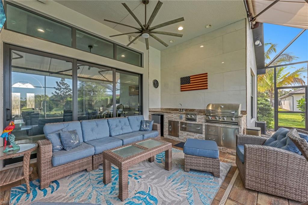 View of patio featuring an outdoor hangout area, ceiling fan, a sunroom, and area for grilling