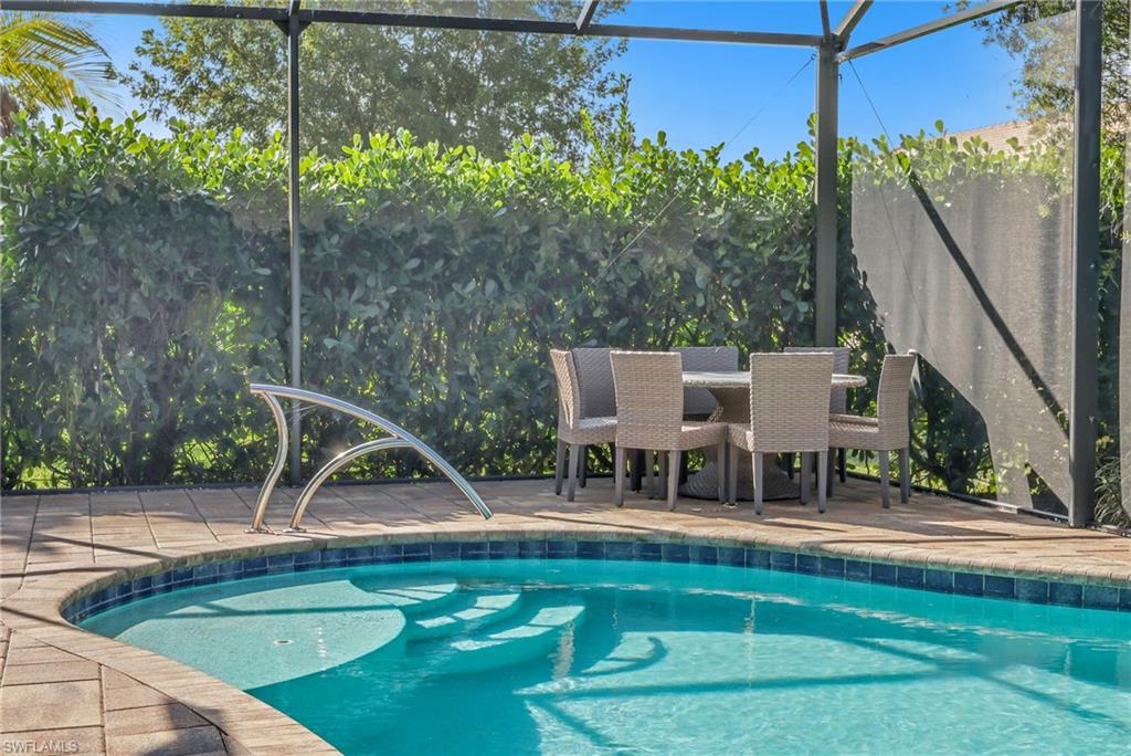 Swimming pool with glass enclosure and a patio