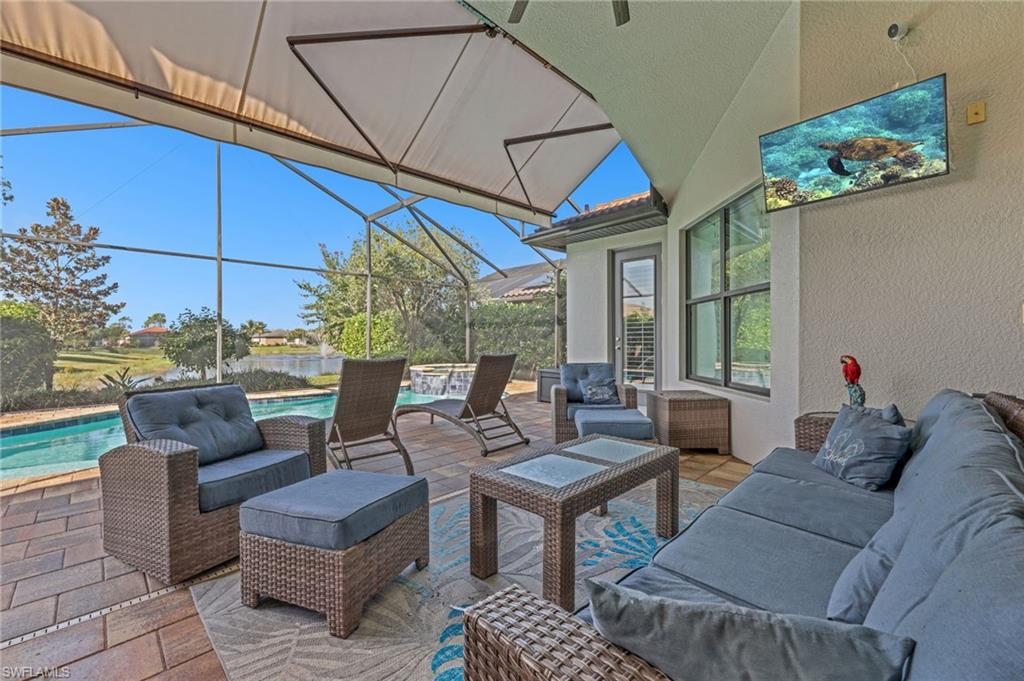 View of patio / terrace with an outdoor pool, an outdoor hangout area, a sunroom, and glass enclosure