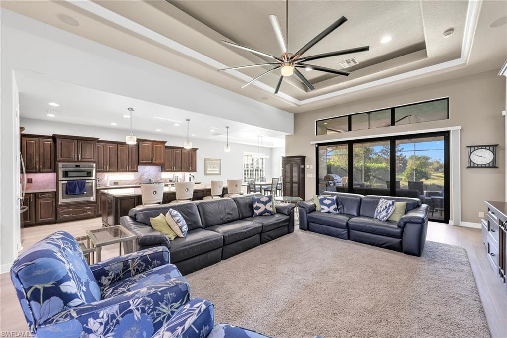 Living area featuring light wood finished floors, recessed lighting, plenty of natural light, and ceiling fan