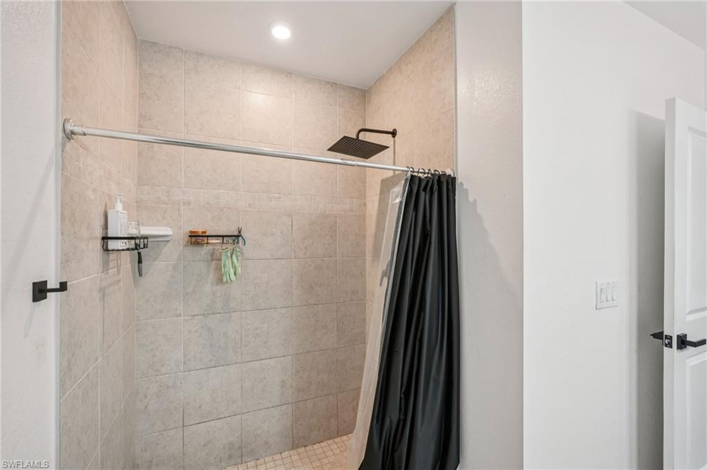 Bathroom with a shower stall and recessed lighting