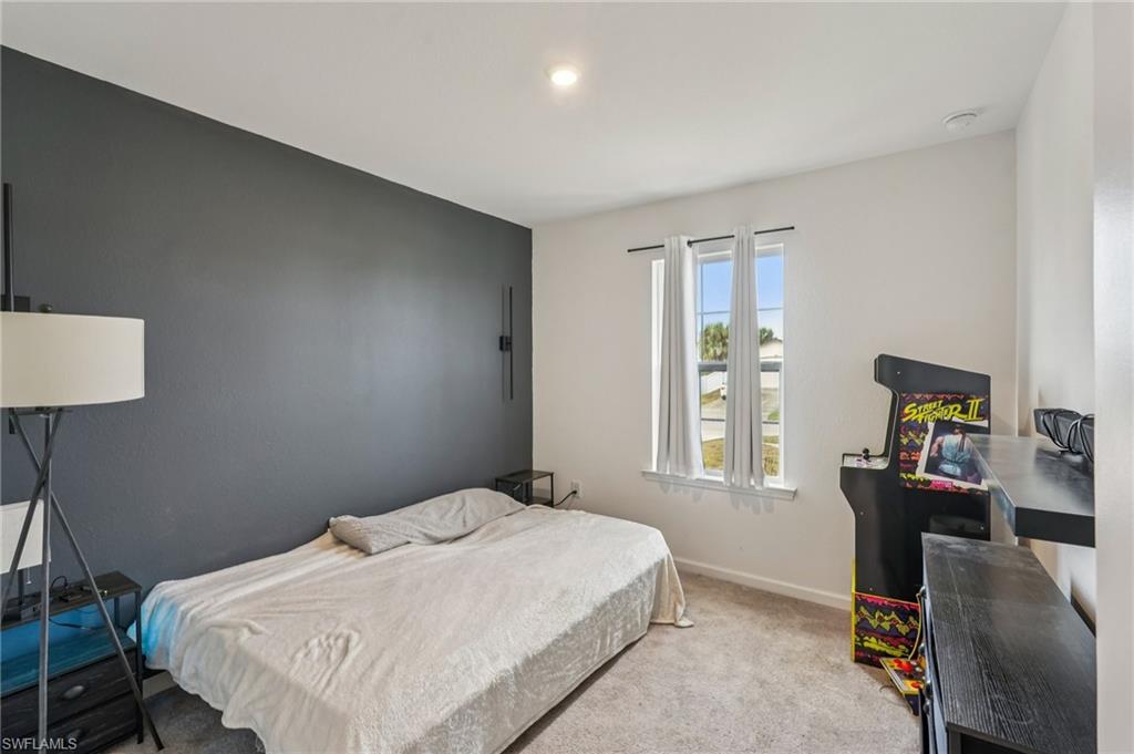 Carpeted bedroom featuring baseboards