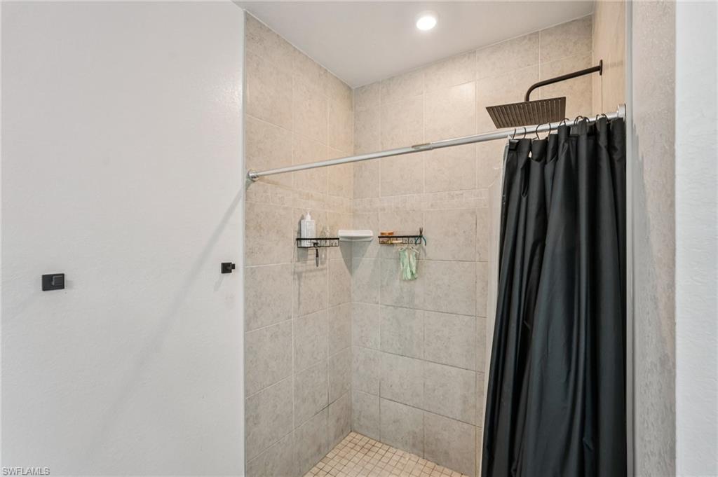 Bathroom featuring a stall shower and recessed lighting