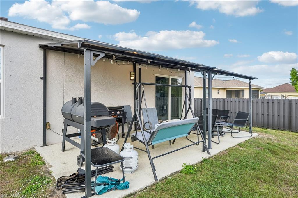 Rear view of property with stucco siding and a patio