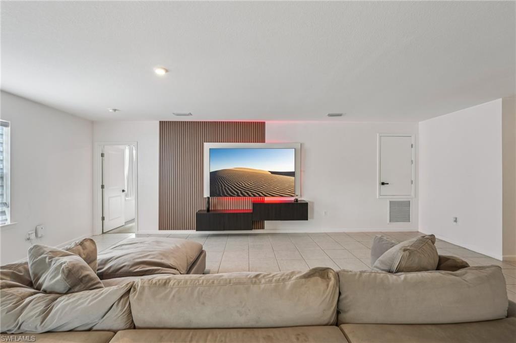 Tiled living area featuring recessed lighting