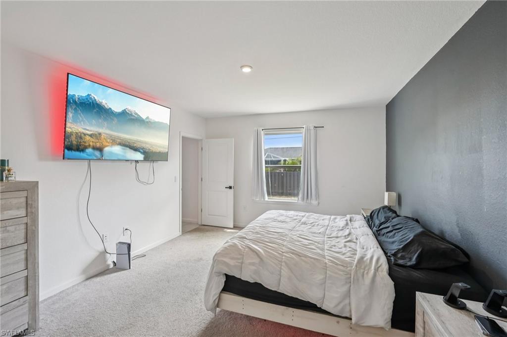 Bedroom with carpet and baseboards