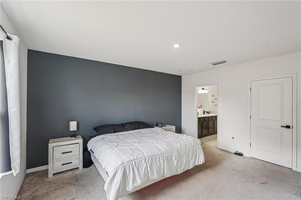 Carpeted bedroom with ensuite bathroom