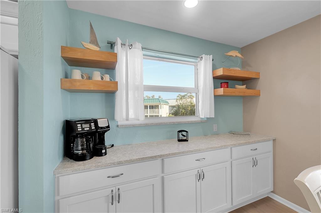 A built-in buffet with sleek quartz and ample cabinetry, offering extra storage and a roomy surface for appetizers or a morning coffee spread.
