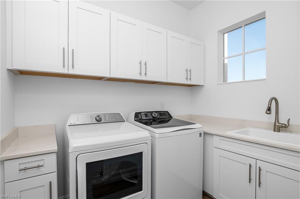Laundry area with cabinet space and washer and dryer