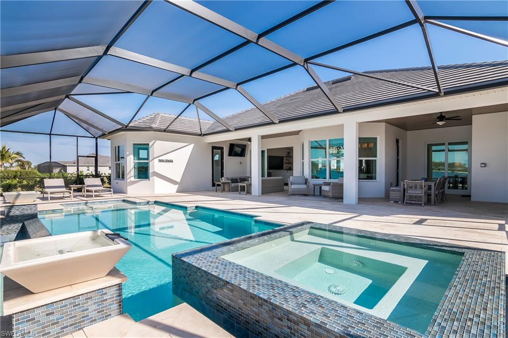 View of swimming pool featuring a sunroom, a patio, a lanai, an outdoor hangout area, and a pool with connected hot tub