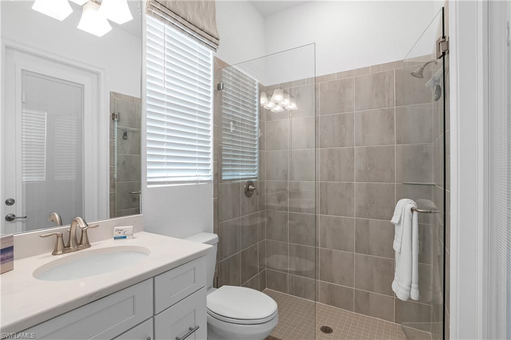Bathroom featuring vanity and a tile shower