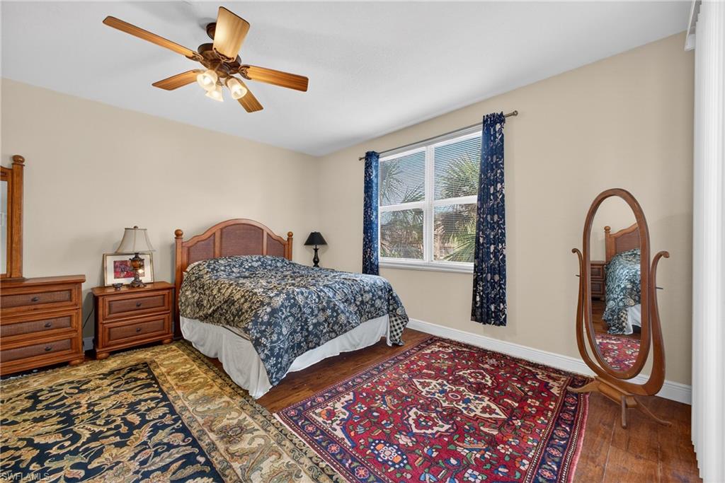 Bedroom featuring hardwood / wood-style flooring and a ceiling fan