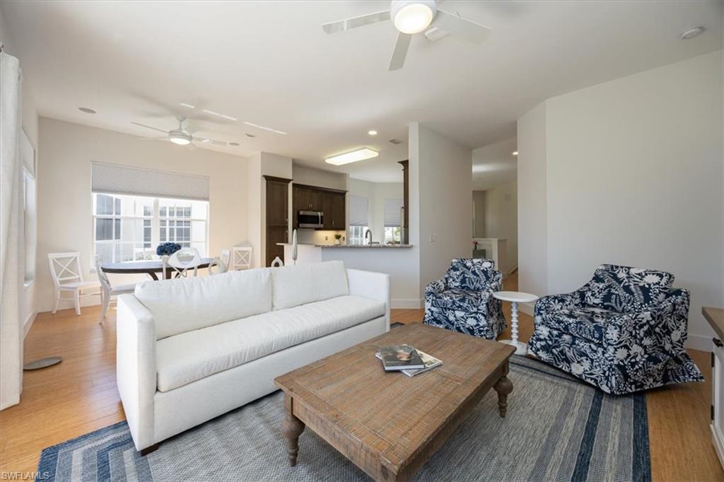 Living room featuring ceiling fan, hardwood / wood-style flooring, and sink