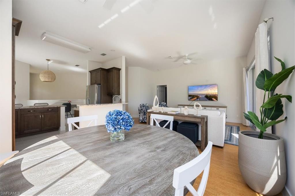 Dining room featuring ceiling fan and light hardwood / wood-style flooring
