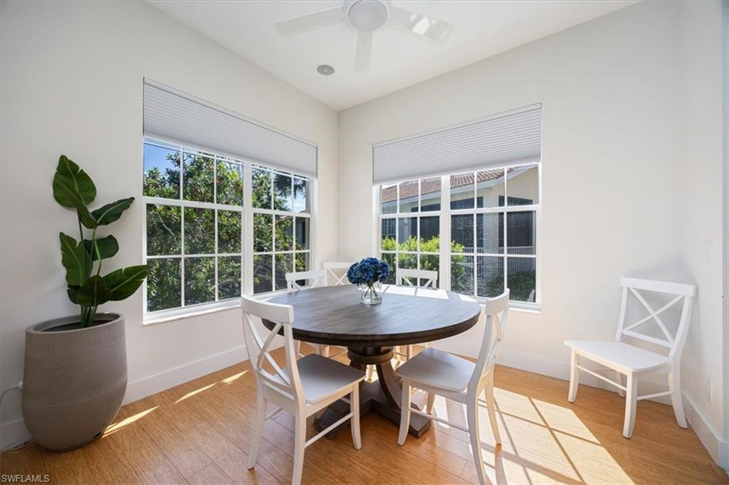 Dining area with ceiling fan and light hardwood / wood-style flooring