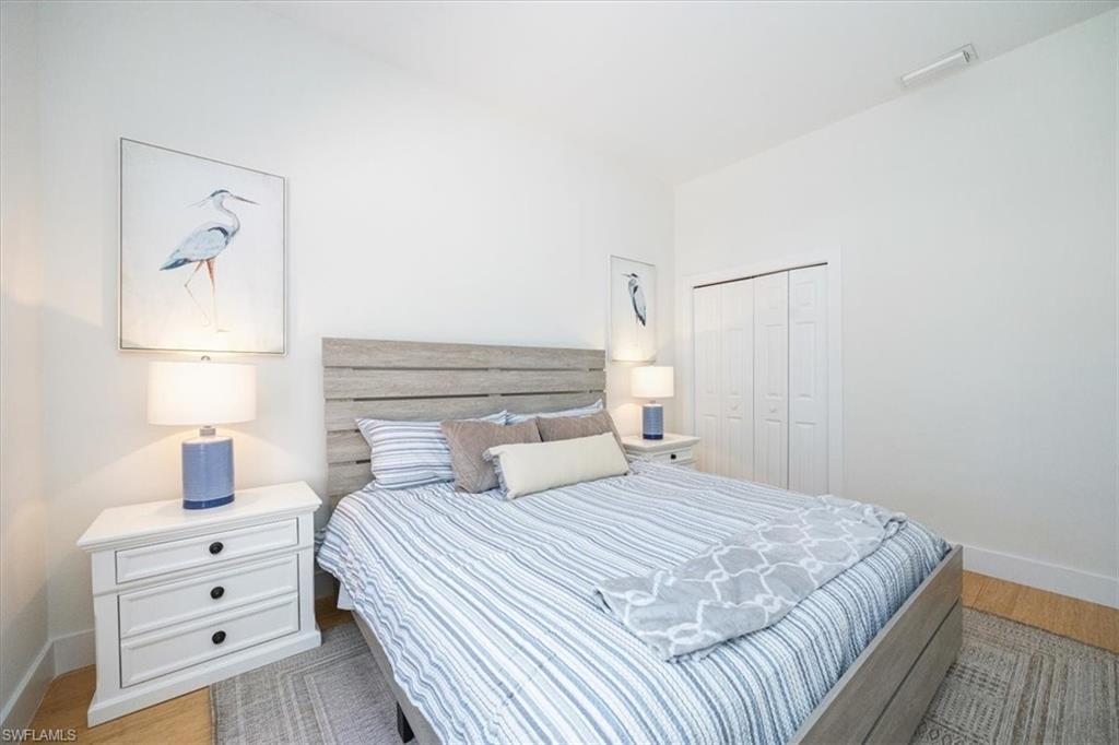 Bedroom with light wood-type flooring and a closet