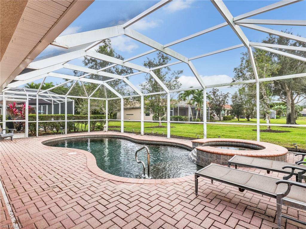 View of swimming pool with connected hot tub