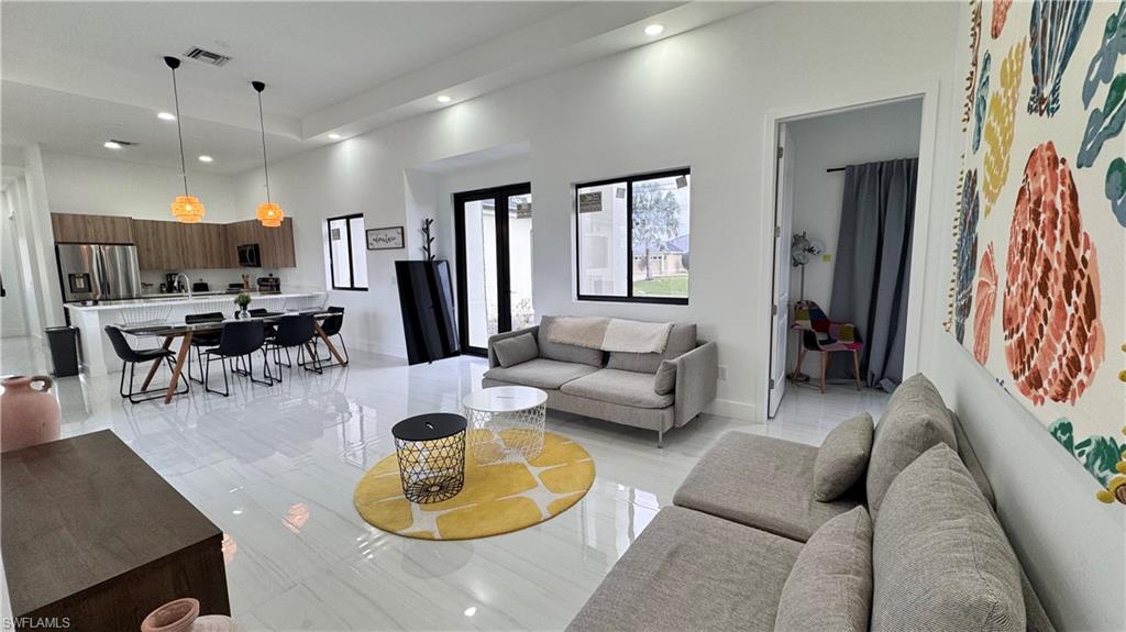 Living area featuring a high ceiling and recessed lighting