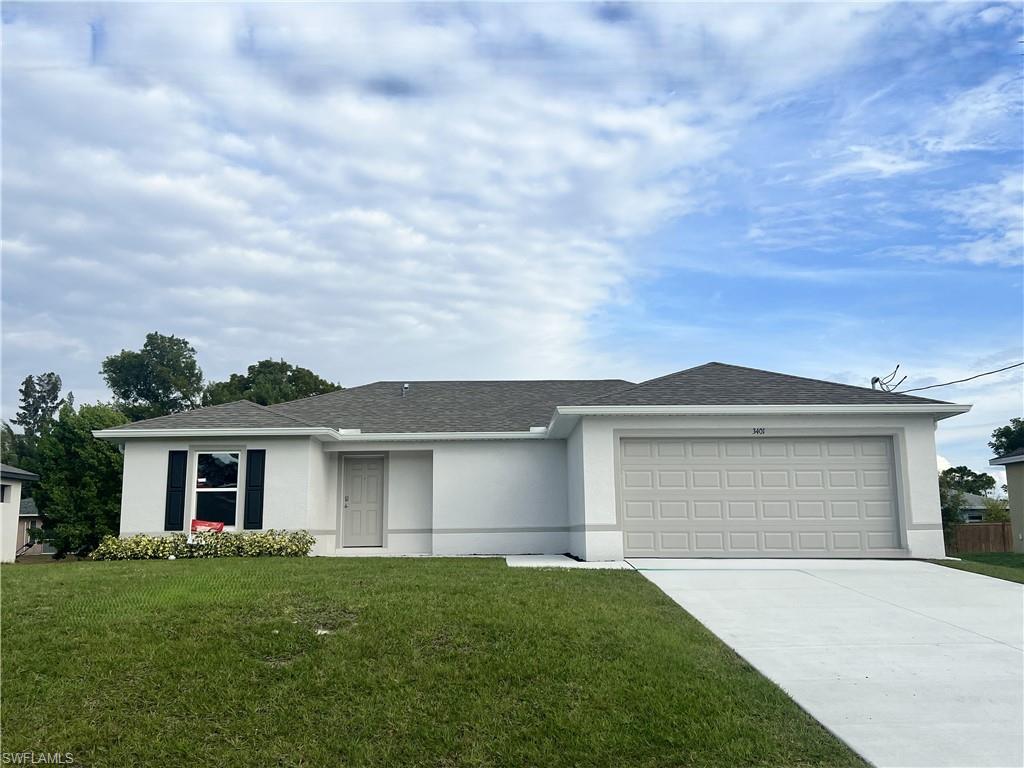 Ranch-style house with stucco siding, a front yard, concrete driveway, roof with shingles, and a garage
