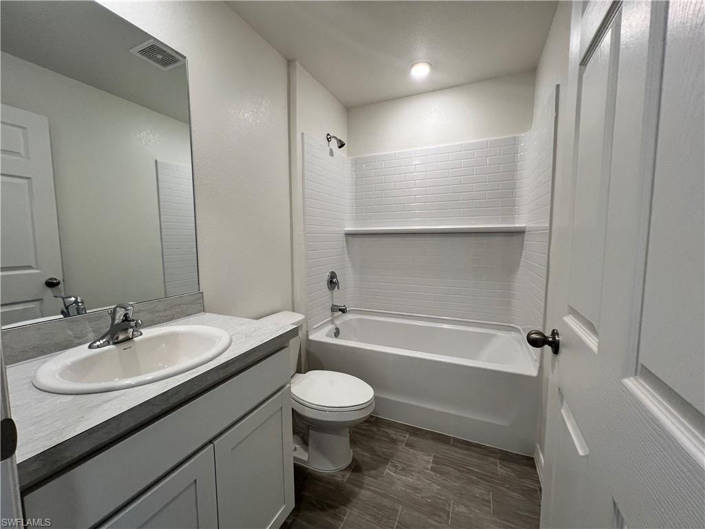 Full bathroom featuring shower / washtub combination, vanity, and wood tiled floors