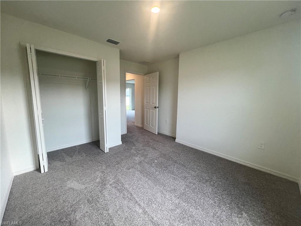 Unfurnished bedroom with carpet floors and a closet