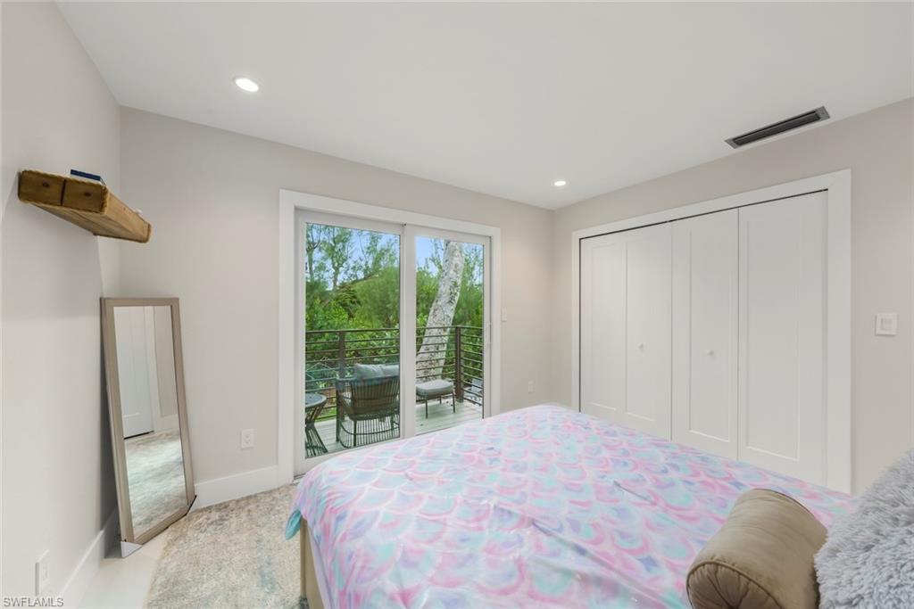 Bedroom with access to outside, a closet, carpet floors, and recessed lighting