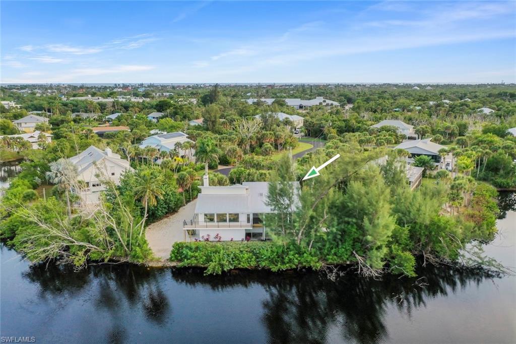 Aerial view of property and surrounding area with a large body of water