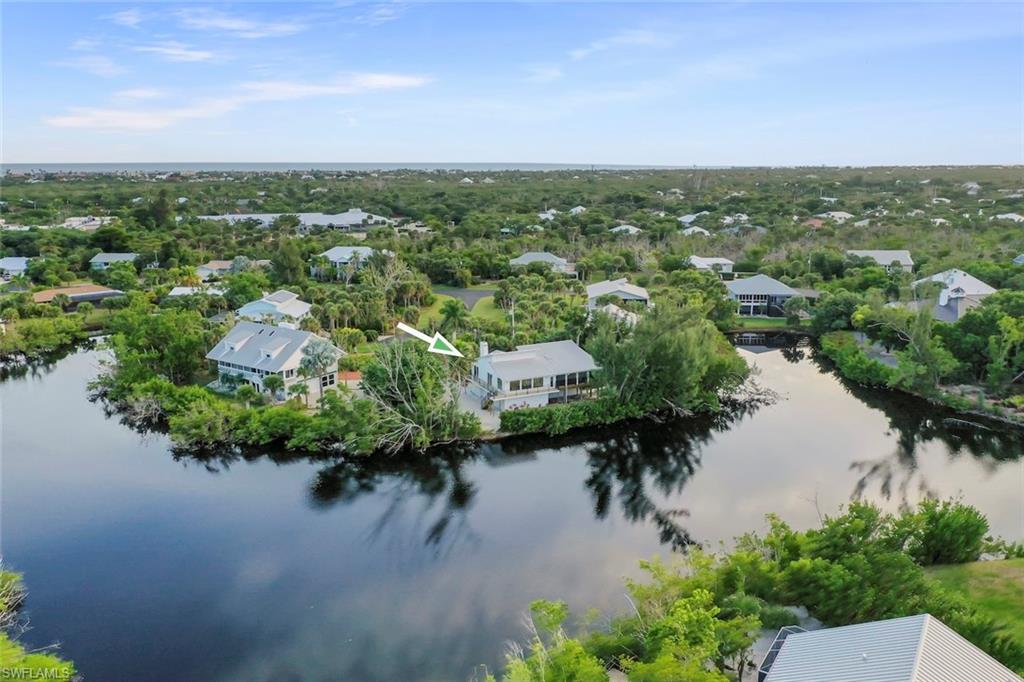 Aerial view of residential area featuring a nearby body of water