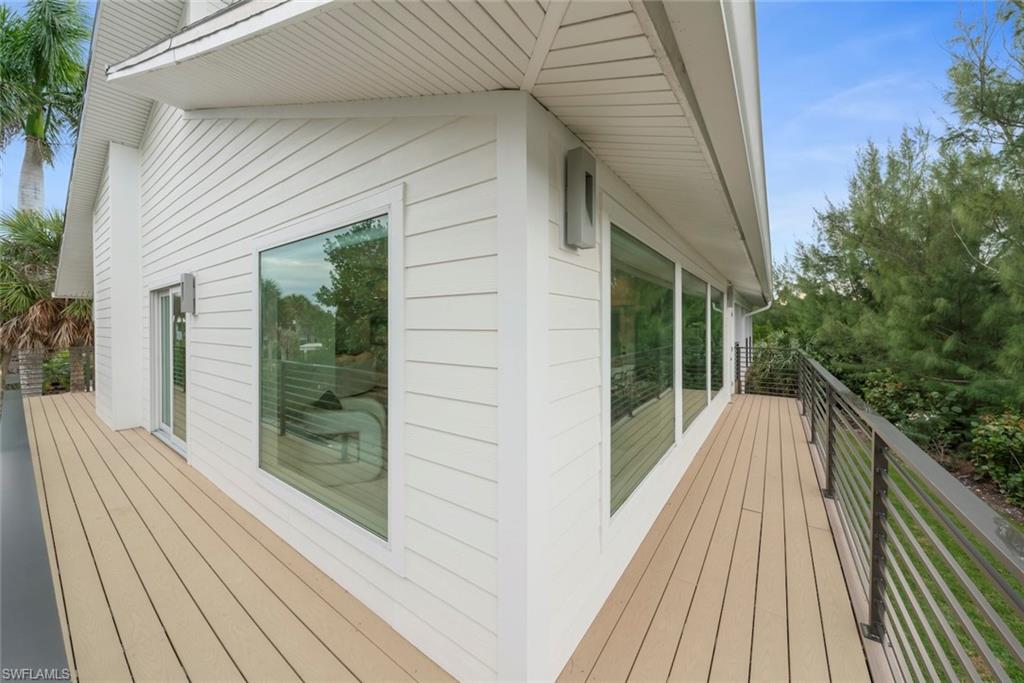 View of side of property featuring a wooden deck