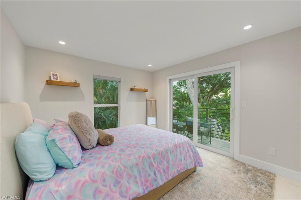 Bedroom with access to outside and recessed lighting