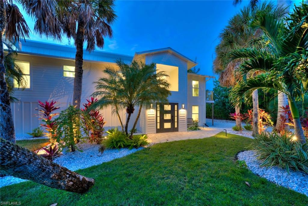 Back of property featuring a yard and stucco siding