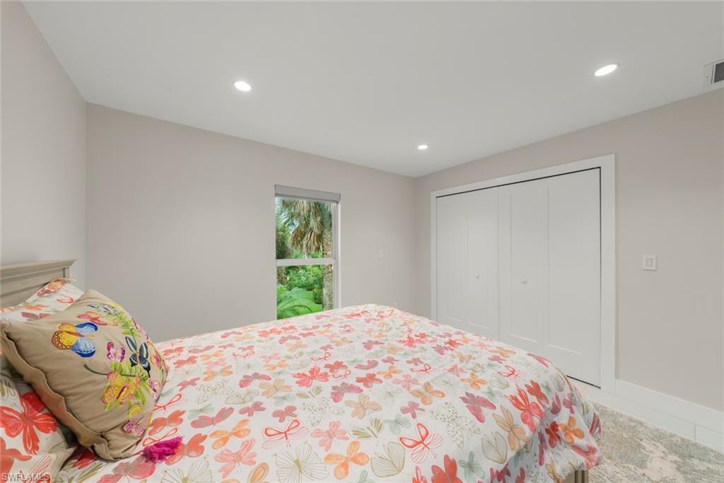 Bedroom with recessed lighting and a closet