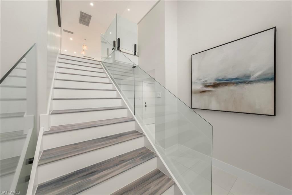 Staircase featuring recessed lighting and baseboards