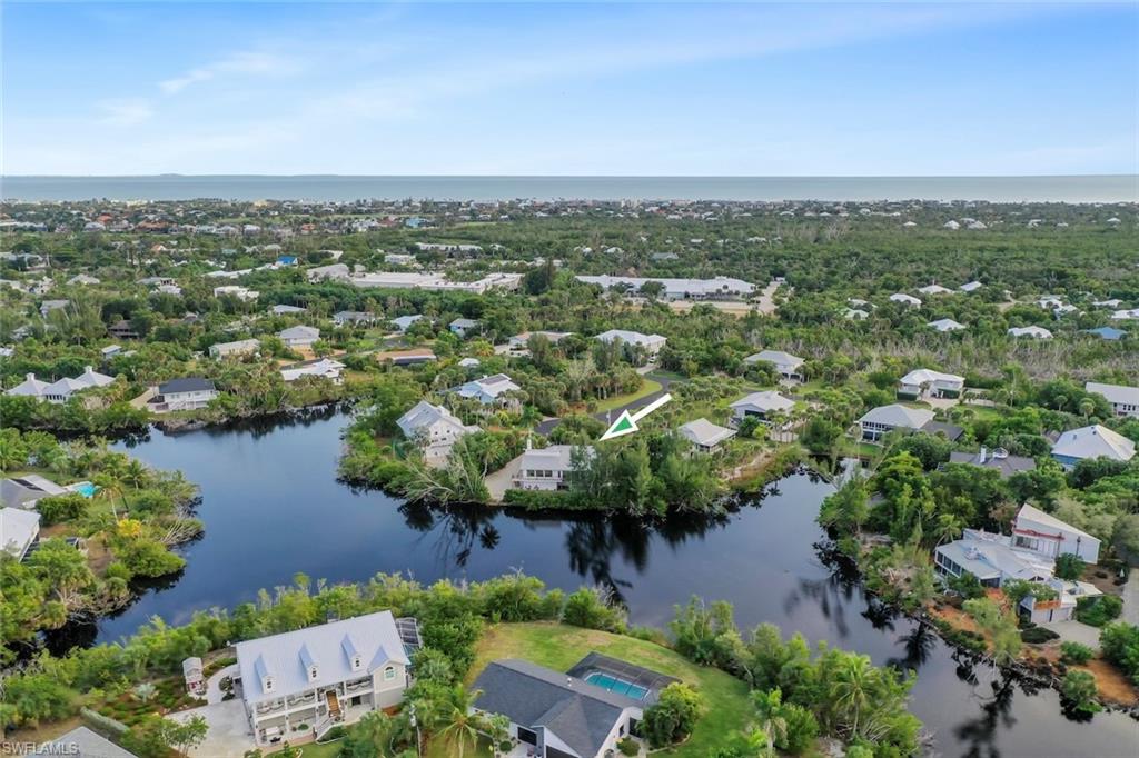 Aerial perspective of suburban area with a nearby body of water