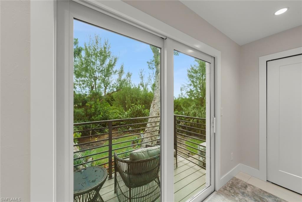Doorway to outside with tile patterned floors and baseboards