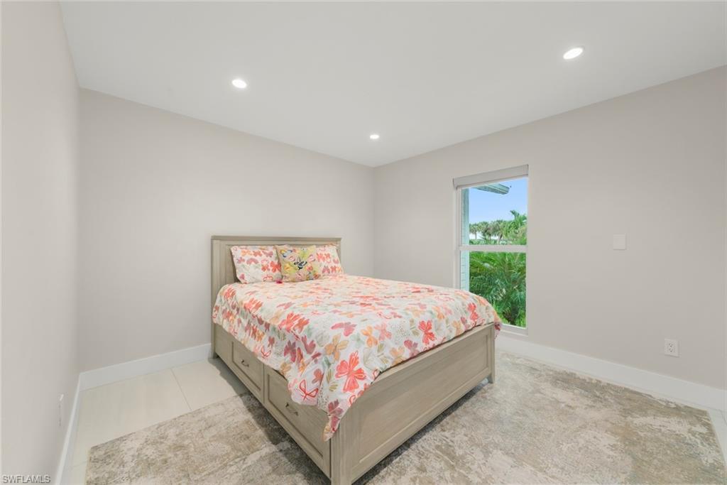 Bedroom with recessed lighting and baseboards