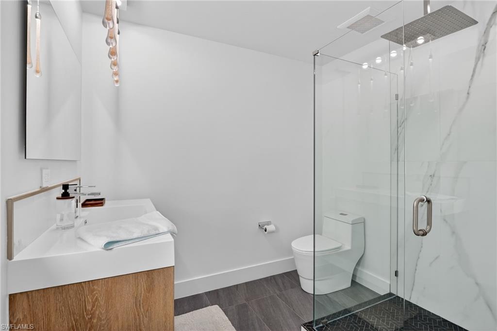 Full bathroom with vanity and a marble finish shower