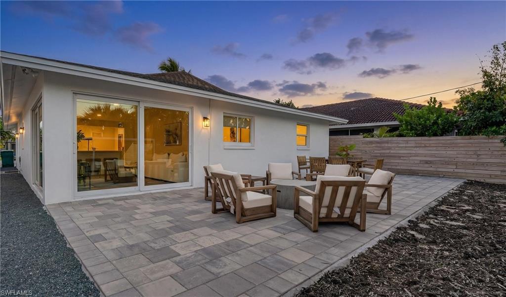 Patio terrace at dusk with an outdoor living space and a patio area