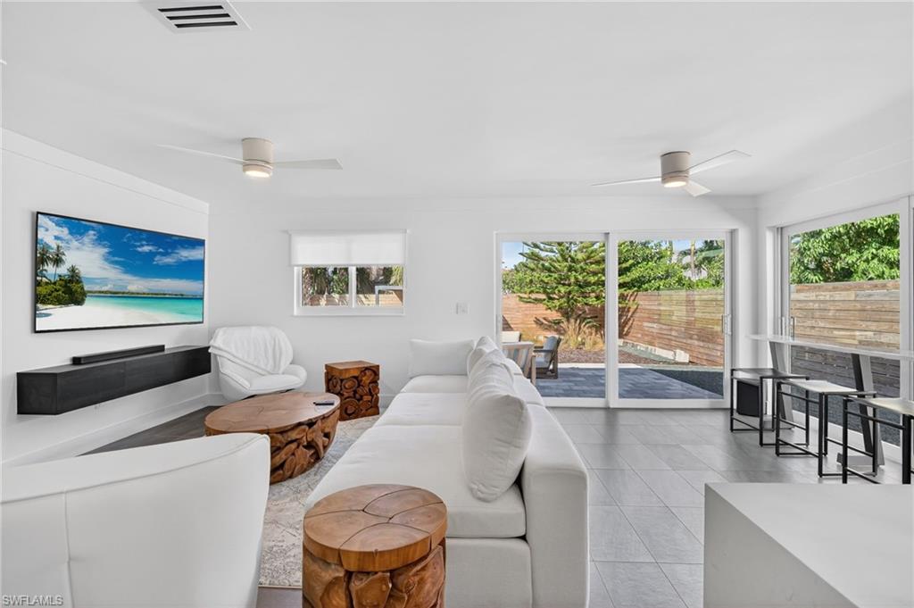 Living room featuring ceiling fan and light tile patterned floors