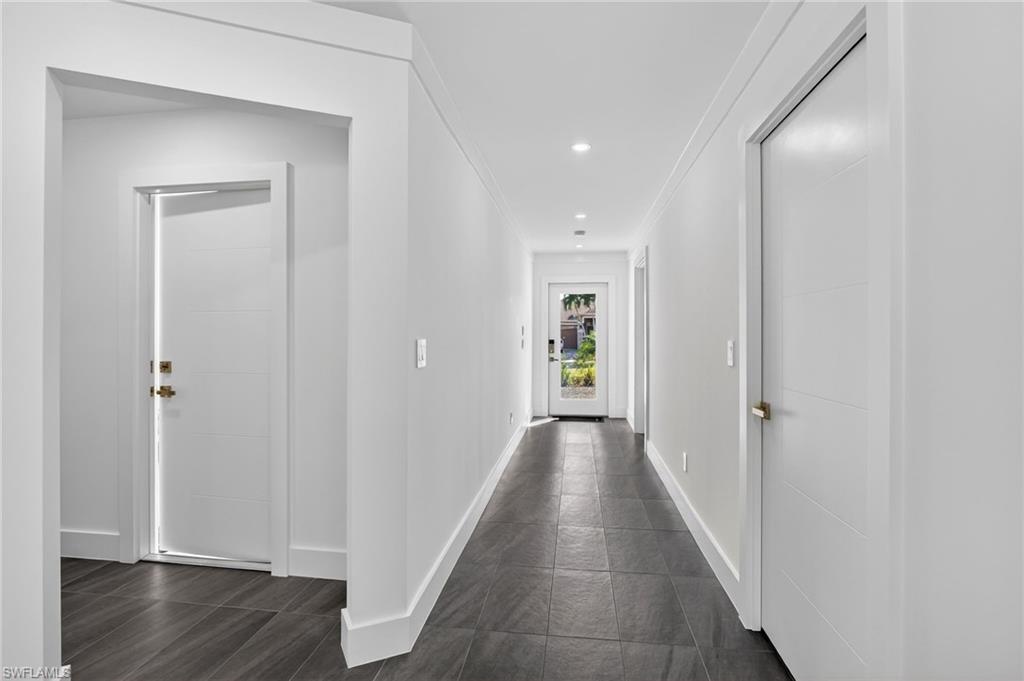 Hallway with crown molding and recessed lighting