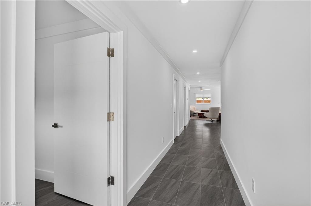 Hallway featuring recessed lighting and ornamental molding