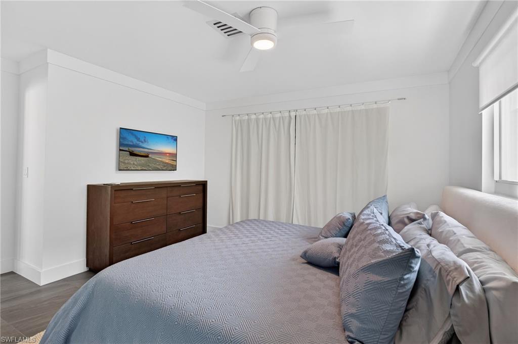 Bedroom with a ceiling fan and dark wood finished floors