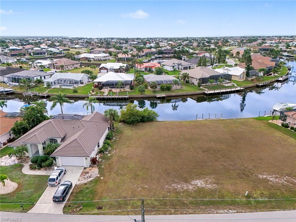 Aerial perspective of suburban area featuring a nearby body of water