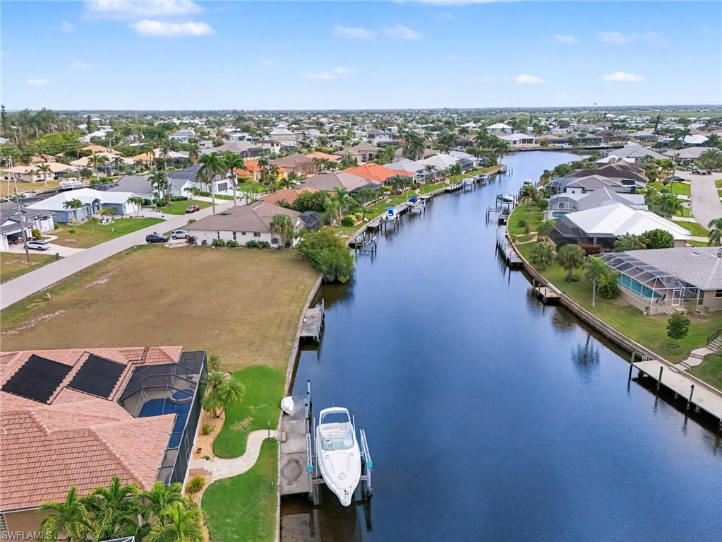 Aerial view of residential area featuring a large body of water
