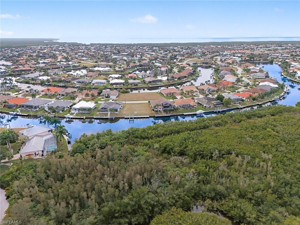 View of property location with a nearby body of water and nearby suburban area