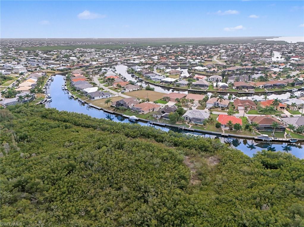 Aerial overview of property's location with a nearby body of water and nearby suburban area