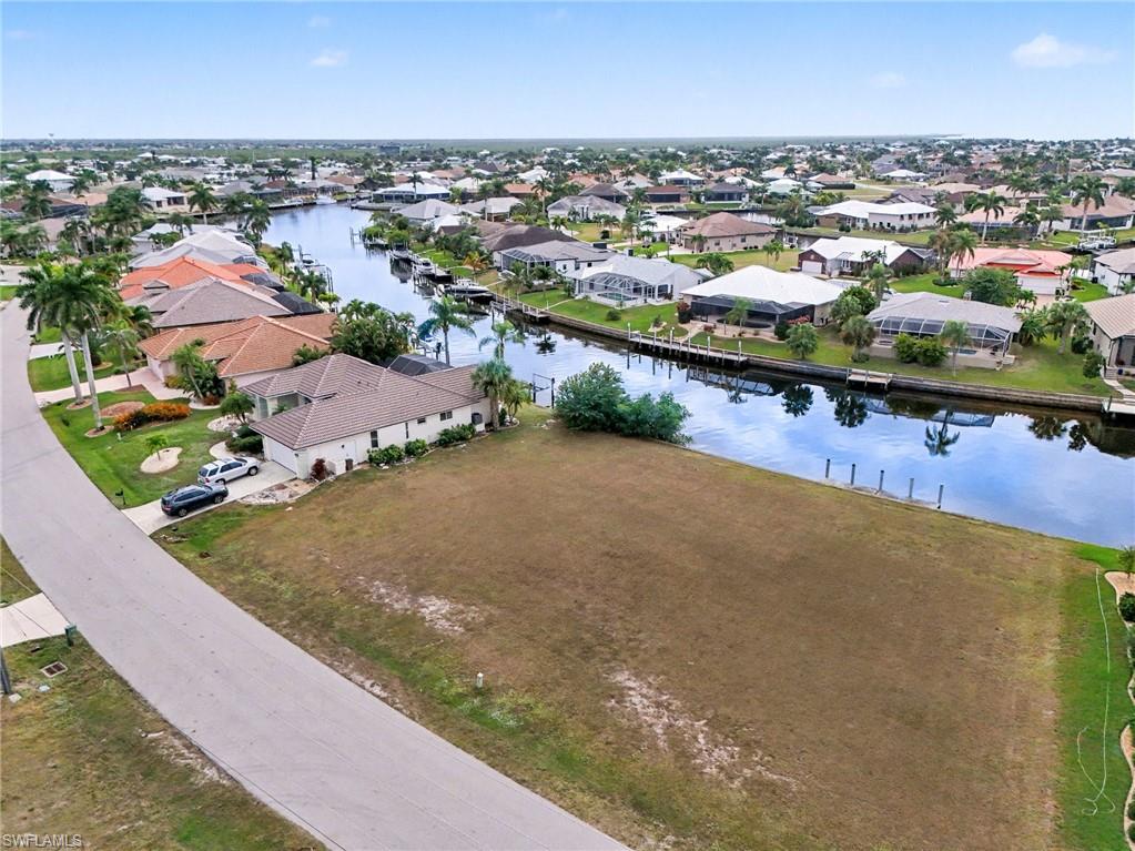 Aerial perspective of suburban area featuring a nearby body of water
