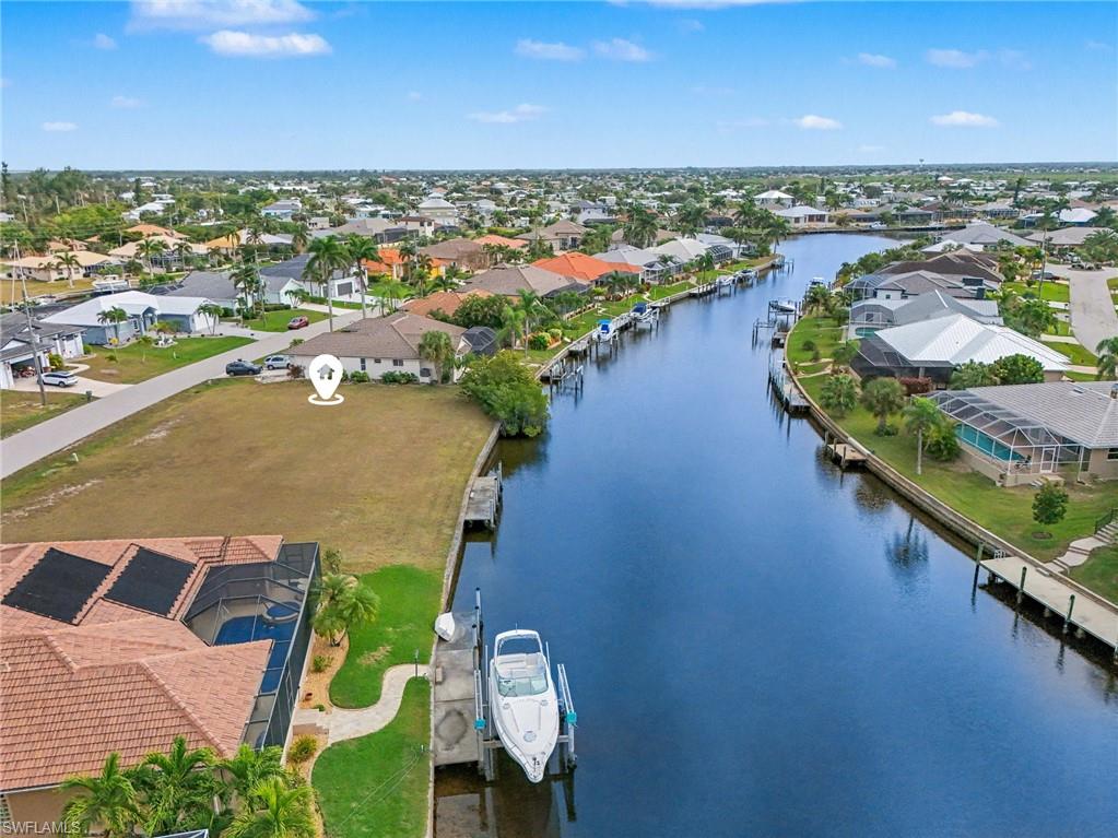 Aerial view of residential area featuring a large body of water