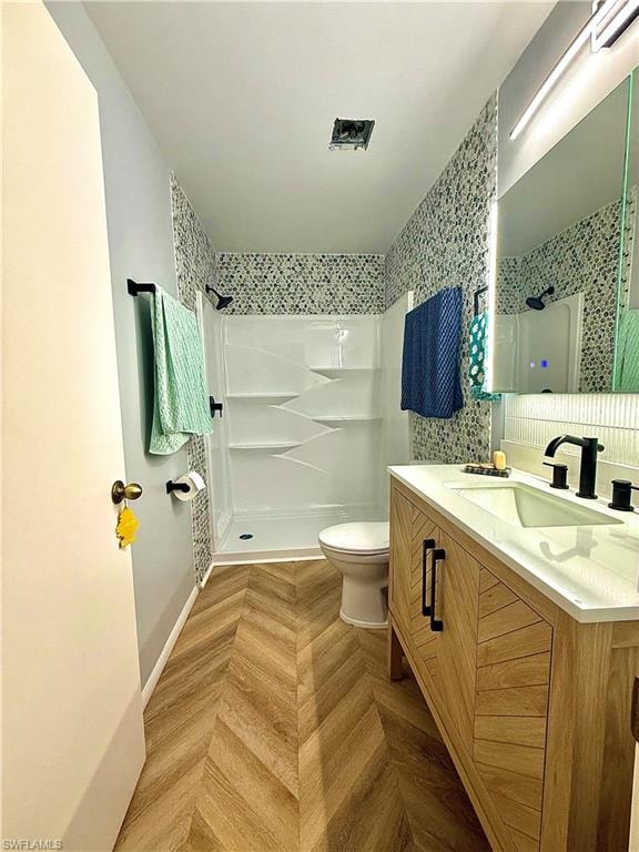 Full bathroom featuring a shower stall and vanity