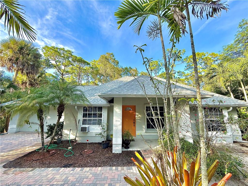 Single story home with roof with shingles, stucco siding, a garage, and covered porch